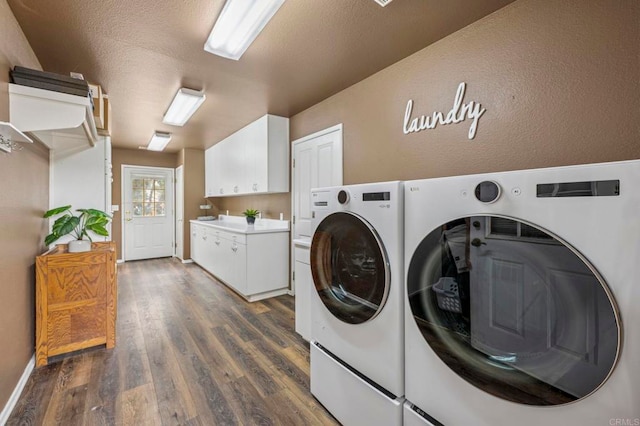 3048 Jason Rd, Fallbrook, CA 92028 - washroom with washer and clothes dryer, cabinet space, dark wood-type flooring, and baseboards