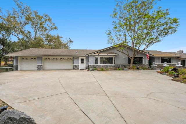 3048 Jason Rd, Fallbrook, CA 92028 - view of front facade featuring stucco siding, stone siding, a garage, and concrete driveway
