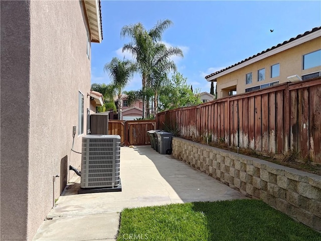 view of yard with cooling unit, a patio, and a fenced backyard