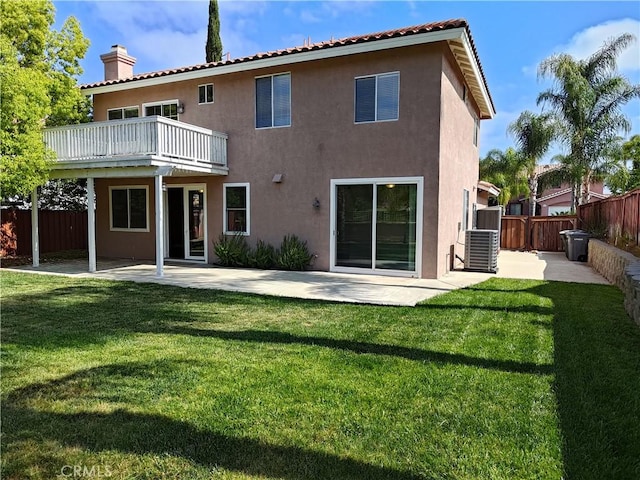 back of property with central air condition unit, stucco siding, a chimney, and fence