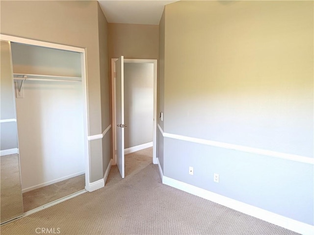 unfurnished bedroom featuring baseboards, a closet, and carpet floors