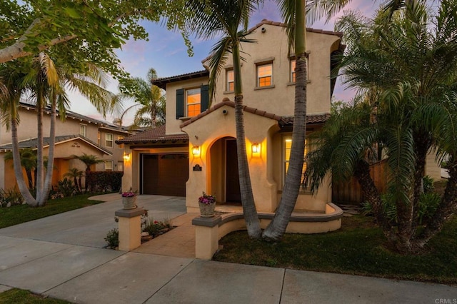 2705 Plumeria Dr, Carlsbad, CA 92009 - mediterranean / spanish house with fence, driveway, a tile roof, a garage, and stucco siding
