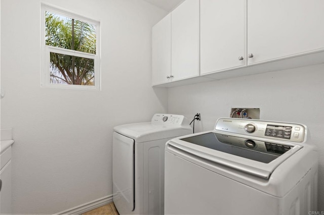 2705 Plumeria Dr, Carlsbad, CA 92009 - clothes washing area with cabinet space, washer and dryer, and baseboards