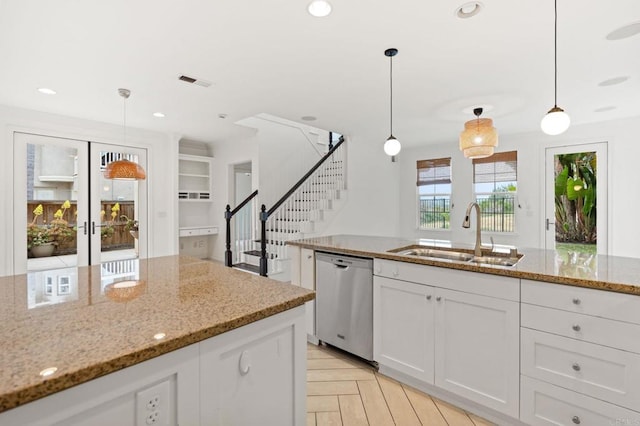 2705 Plumeria Dr, Carlsbad, CA 92009 - kitchen with a sink, light stone counters, visible vents, dishwasher, and white cabinets