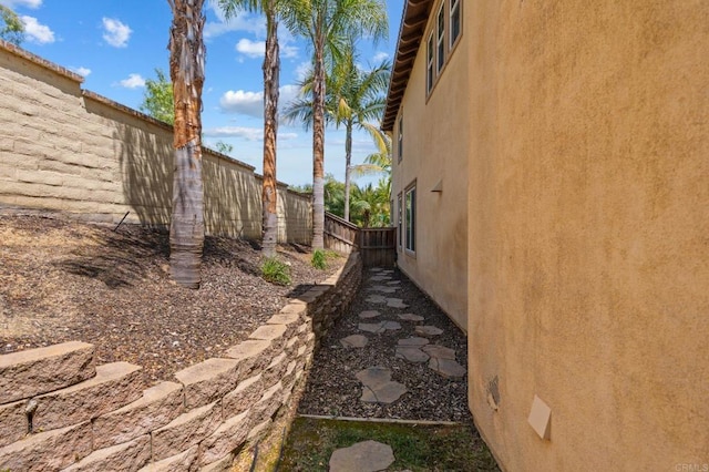 2705 Plumeria Dr, Carlsbad, CA 92009 - view of side of home with a fenced backyard and stucco siding
