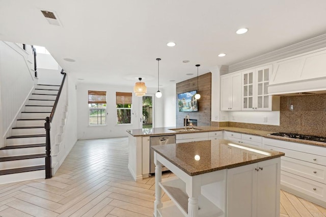 2705 Plumeria Dr, Carlsbad, CA 92009 - kitchen featuring backsplash, a peninsula, appliances with stainless steel finishes, and a sink