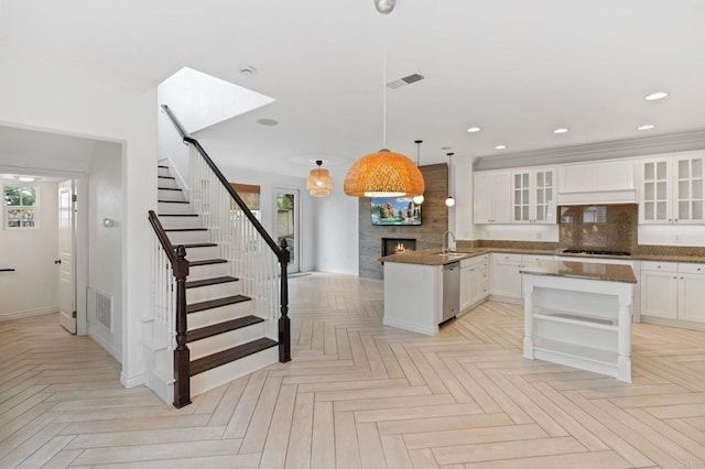 2705 Plumeria Dr, Carlsbad, CA 92009 - kitchen featuring a peninsula, a sink, a wealth of natural light, a large fireplace, and dishwasher