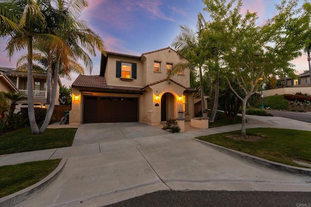 2705 Plumeria Dr, Carlsbad, CA 92009 - mediterranean / spanish home with stucco siding, concrete driveway, a garage, and a tiled roof