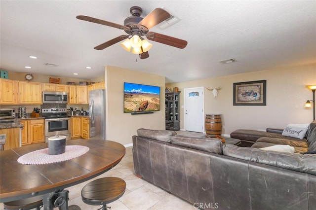 150020 Bluewater Rd, Big River, CA 92242 - living area featuring recessed lighting, a toaster, ceiling fan, light tile patterned floors, and baseboards