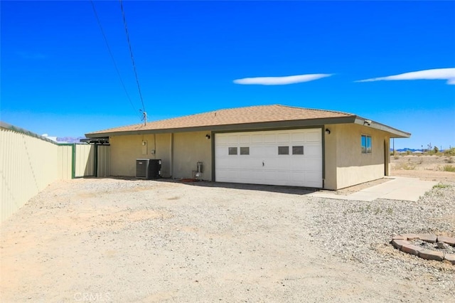 150020 Bluewater Rd, Big River, CA 92242 - back of property with central AC unit, a detached garage, and fence