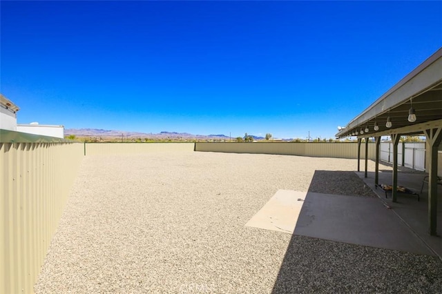 150020 Bluewater Rd, Big River, CA 92242 - view of yard featuring a mountain view, a patio, and a fenced backyard