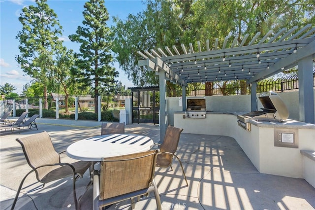 view of patio / terrace with exterior kitchen, a pergola, fence, and grilling area