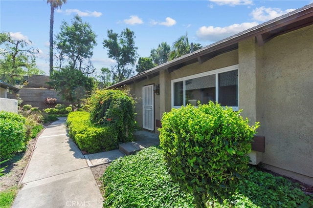property entrance featuring stucco siding