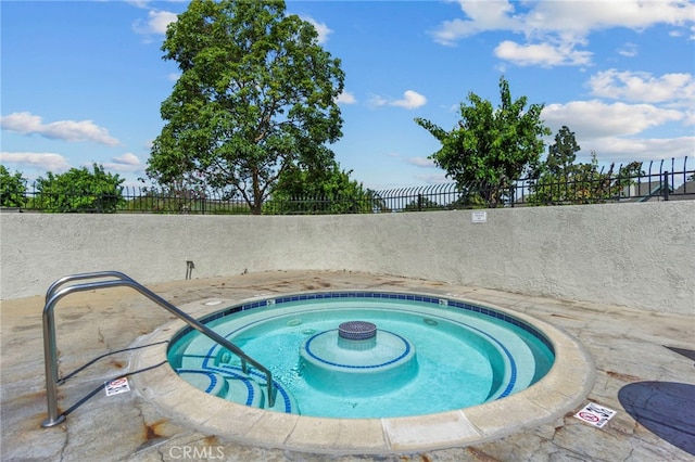 view of swimming pool featuring fence