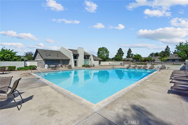 pool with fence and a patio
