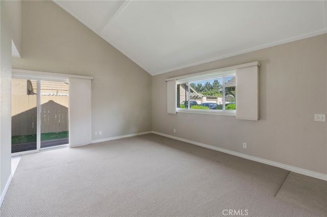 empty room with carpet flooring, baseboards, and lofted ceiling