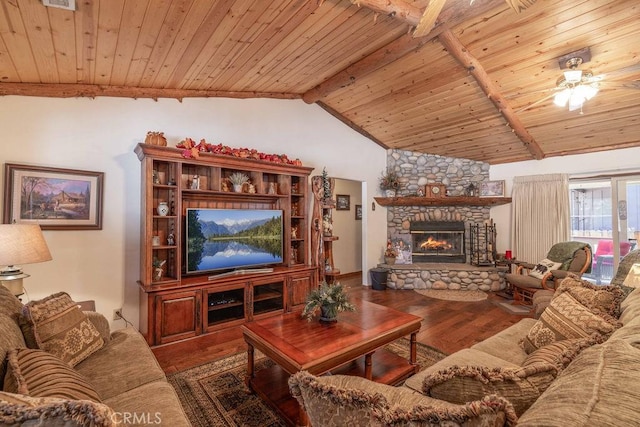 living area featuring a ceiling fan, a stone fireplace, wood ceiling, wood finished floors, and vaulted ceiling with beams