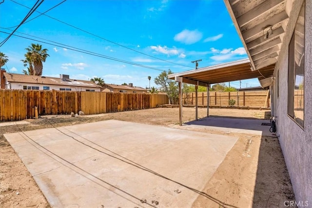 view of patio / terrace featuring a carport and a fenced backyard