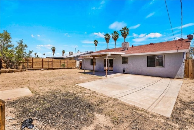 back of house featuring stucco siding, a fenced backyard, and a patio