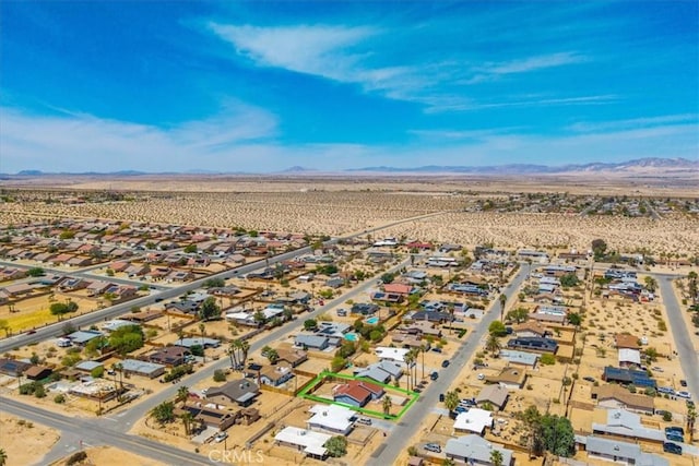 birds eye view of property featuring a mountain view, a desert view, and a residential view