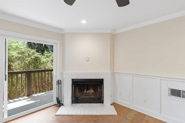 3527 Caminito Sierra Unit 202, Carlsbad, CA 92009 - detailed view of ceiling fan, a brick fireplace, ornamental molding, wainscoting, and wood finished floors