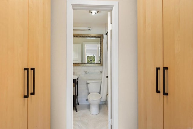 3527 Caminito Sierra Unit 202, Carlsbad, CA 92009 - bathroom with tile patterned floors, toilet, tile walls, and vanity