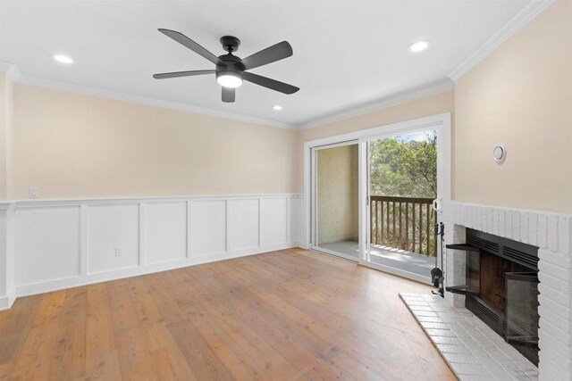 3527 Caminito Sierra Unit 202, Carlsbad, CA 92009 - unfurnished living room featuring a fireplace, wood finished floors, ornamental molding, a wainscoted wall, and ceiling fan