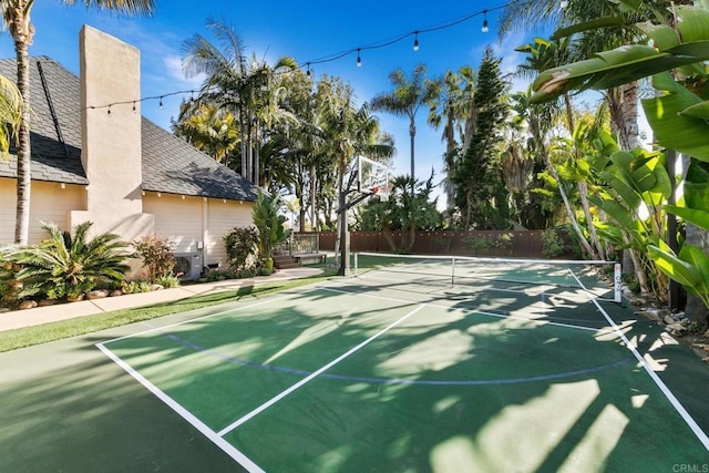 view of basketball court featuring fence and a tennis court