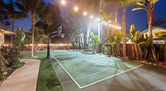view of basketball court with fence and a tennis court
