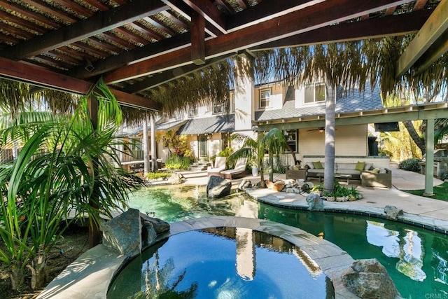view of swimming pool featuring outdoor lounge area, a patio, ceiling fan, and a pool with connected hot tub