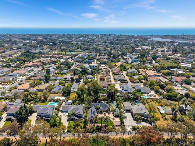 drone / aerial view with a water view and a residential view