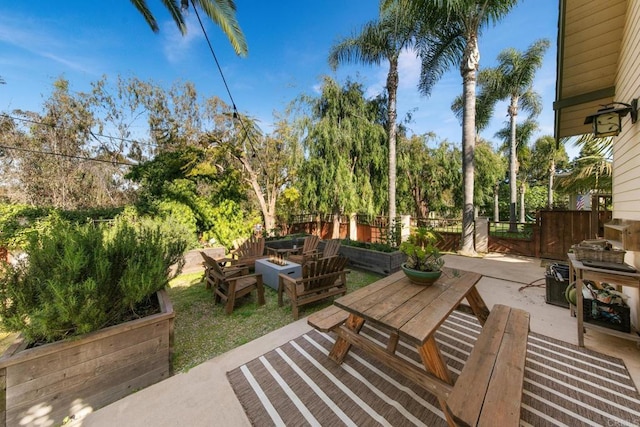 view of patio / terrace featuring a fire pit and a fenced backyard