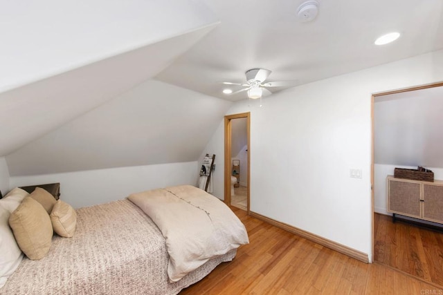 bedroom featuring vaulted ceiling, wood finished floors, baseboards, and ceiling fan