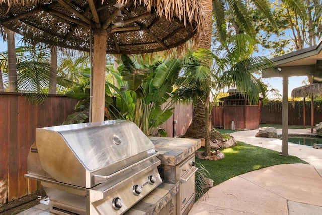 view of yard featuring area for grilling, a patio, a gazebo, and a fenced backyard