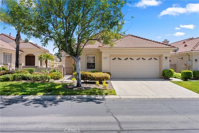 40050 Corte Fortuna, Murrieta, CA 92562 - view of front of home featuring driveway, stucco siding, a tiled roof, and an attached garage
