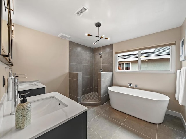 full bathroom with walk in shower, visible vents, tile patterned floors, a freestanding bath, and double vanity