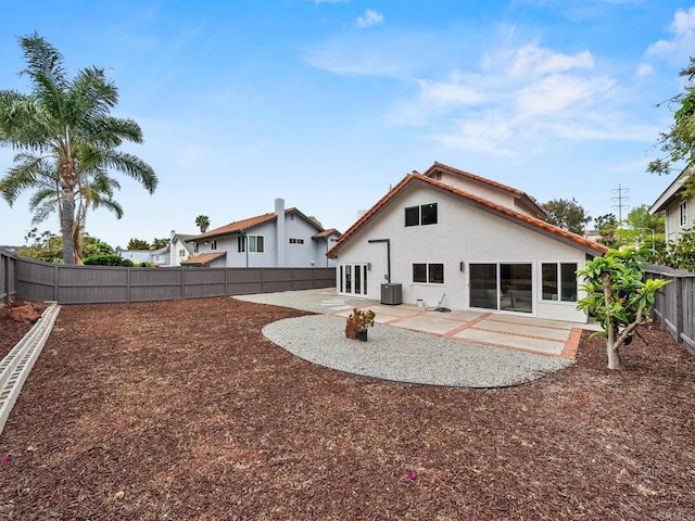 back of house featuring cooling unit, a patio, stucco siding, and a fenced backyard