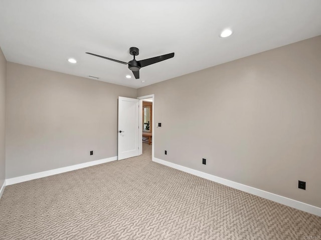 spare room with visible vents, recessed lighting, light carpet, a ceiling fan, and baseboards