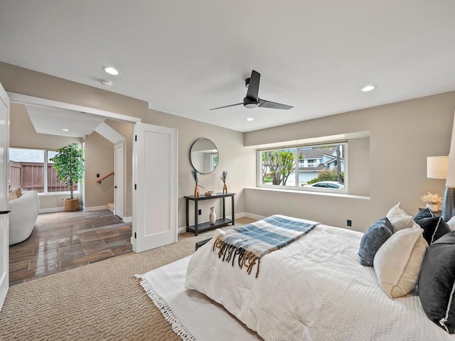 bedroom with baseboards, multiple windows, and recessed lighting
