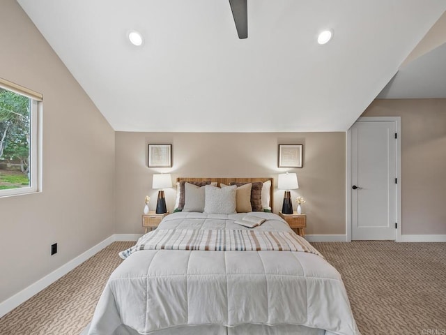 bedroom featuring carpet flooring, vaulted ceiling, baseboards, and ceiling fan