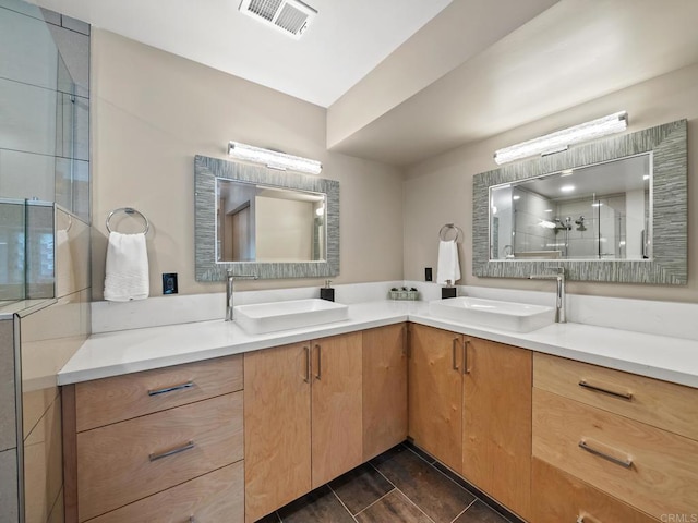 bathroom featuring vanity, visible vents, and a shower stall