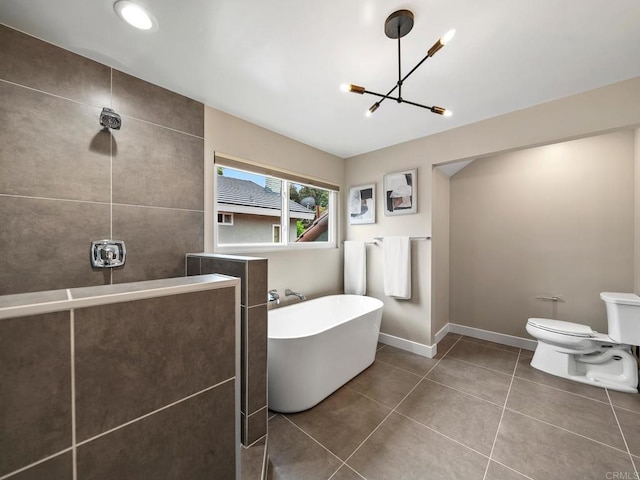 full bath with a soaking tub, toilet, a chandelier, and a tile shower