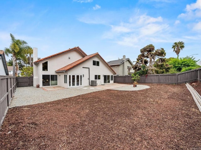 back of house with a patio, french doors, stucco siding, and a fenced backyard