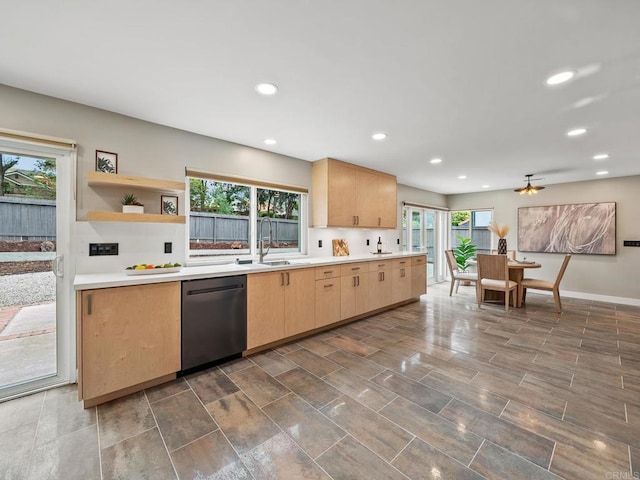 kitchen featuring a sink, recessed lighting, light brown cabinetry, light countertops, and stainless steel dishwasher