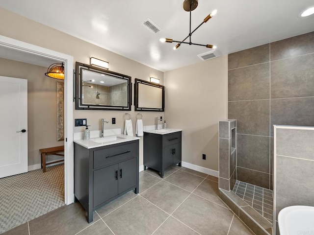 bathroom featuring visible vents, a sink, a walk in shower, a chandelier, and two vanities