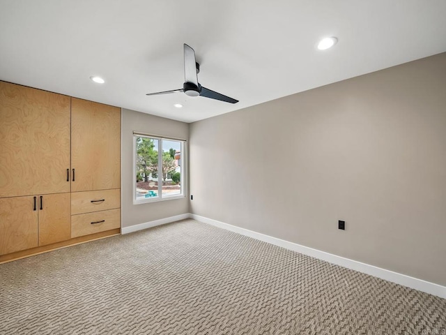 unfurnished bedroom with light carpet, baseboards, a ceiling fan, and recessed lighting