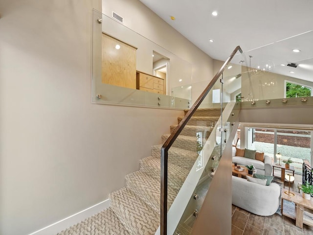 stairway featuring visible vents and recessed lighting