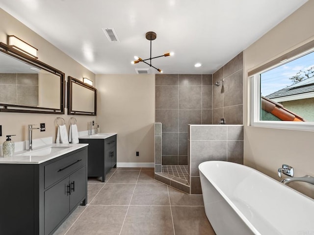 full bathroom featuring a sink, walk in shower, visible vents, tile patterned floors, and two vanities