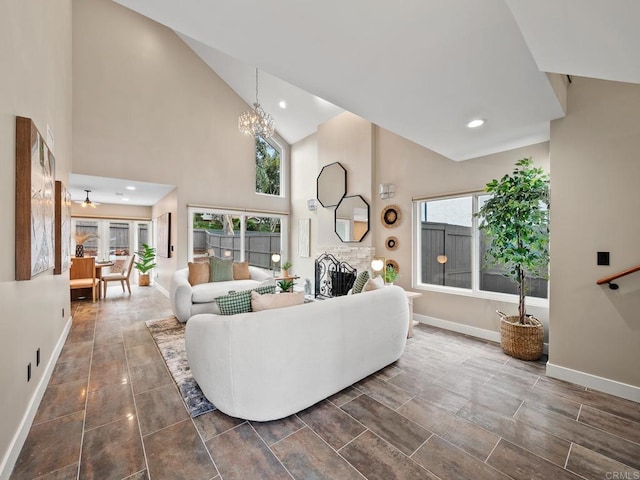 living area featuring a notable chandelier, recessed lighting, baseboards, and high vaulted ceiling