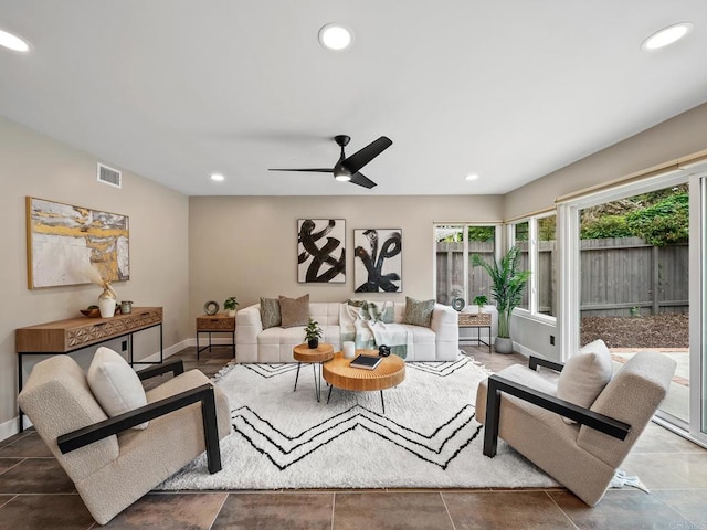 living room featuring baseboards, recessed lighting, ceiling fan, and visible vents